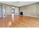 Open living room with hardwood floors and French doors to the exterior of the home at 1341 W Lakeshore Dr, Clermont, FL 34711