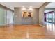 Open-concept living area with hardwood floors and an open view into the modern kitchen at 1341 W Lakeshore Dr, Clermont, FL 34711