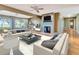 Cozy living room featuring a fireplace, ceiling fans, and beautiful water views at 1341 W Lakeshore Dr, Clermont, FL 34711