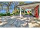 Covered patio with stone flooring and a view of landscaped lawn and the waterfront at 1341 W Lakeshore Dr, Clermont, FL 34711