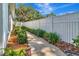 Landscaped side yard with white fence and walkway at 1341 W Lakeshore Dr, Clermont, FL 34711