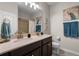 Bathroom featuring a double sink vanity, large mirror, and decorative wall art at 14430 Desert Haven St # 4302, Windermere, FL 34786