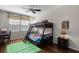 Bright bedroom with bunk beds, wood floors, and a view of the backyard at 14430 Desert Haven St # 4302, Windermere, FL 34786