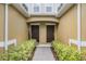A welcoming entryway featuring dual front doors, a brick pathway, and manicured landscaping at 14430 Desert Haven St # 4302, Windermere, FL 34786