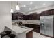Well-lit kitchen featuring stainless steel appliances, dark wood cabinetry, and a breakfast bar with seating at 14430 Desert Haven St # 4302, Windermere, FL 34786