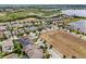 Neighborhood aerial view featuring a scenic lake and rows of houses on a clear, sunny day at 14513 Winter Stay Dr, Winter Garden, FL 34787