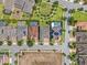 An aerial view of a neighborhood showcasing houses with pools and solar panels on a sunny day at 14513 Winter Stay Dr, Winter Garden, FL 34787