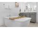 This relaxing bathroom features a soaking tub with bamboo caddy and bright natural light at 14513 Winter Stay Dr, Winter Garden, FL 34787
