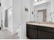 Clean bathroom features a granite vanity, dark wood cabinets and a shower/tub combo at 14513 Winter Stay Dr, Winter Garden, FL 34787