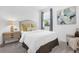 This bedroom features a comfy bed, side table, and accent chair next to a window at 14513 Winter Stay Dr, Winter Garden, FL 34787