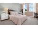 This cozy bedroom features a pink comforter, plenty of sunlight, and a small desk at 14513 Winter Stay Dr, Winter Garden, FL 34787