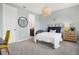 Bedroom with soft blue walls, a unique light fixture, and a glimpse into an en-suite bathroom at 14513 Winter Stay Dr, Winter Garden, FL 34787