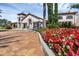 Inviting clubhouse exterior surrounded by vibrant flower beds and lush greenery for a welcoming atmosphere at 14513 Winter Stay Dr, Winter Garden, FL 34787