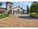 Attractive clubhouse with stone tower, manicured landscaping, and brick driveway, offering a sophisticated community gathering space at 14513 Winter Stay Dr, Winter Garden, FL 34787