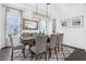 Elegant dining room featuring a rustic wood table, modern lighting, and chic decor at 14513 Winter Stay Dr, Winter Garden, FL 34787