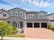 Beautiful two-story home featuring a brick driveway and a three-car garage at 14513 Winter Stay Dr, Winter Garden, FL 34787