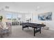 Bright game room with pool table, seating, and large windows showcasing the outdoor view at 14513 Winter Stay Dr, Winter Garden, FL 34787