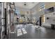 Bright gym with modern equipment, large windows, and mounted televisions at 14513 Winter Stay Dr, Winter Garden, FL 34787