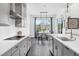 Bright kitchen features gray cabinets, white countertops, stainless steel appliances, and a dining nook at 14513 Winter Stay Dr, Winter Garden, FL 34787