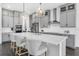 Stylish kitchen boasts gray cabinets, white countertops, a large island with seating, and modern pendant lighting at 14513 Winter Stay Dr, Winter Garden, FL 34787
