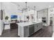 Open-concept kitchen with gray cabinets, white countertops, stainless appliances, and a view into the living room at 14513 Winter Stay Dr, Winter Garden, FL 34787