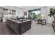 Open concept living room connected to a modern kitchen with a large sofa and natural light at 14513 Winter Stay Dr, Winter Garden, FL 34787