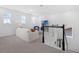 Bright living room with a modern staircase, large windows, and a comfortable seating area with TV at 14513 Winter Stay Dr, Winter Garden, FL 34787
