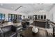 A community clubhouse lounge area with lots of natural light, modern sofas and chairs, and access to the outdoor pool at 14513 Winter Stay Dr, Winter Garden, FL 34787