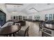 A community clubhouse lounge area with lots of natural light, tables, and comfortable modern sofas and chairs at 14513 Winter Stay Dr, Winter Garden, FL 34787