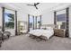 Bright main bedroom features lots of windows, a tray ceiling, and neutral decor at 14513 Winter Stay Dr, Winter Garden, FL 34787