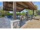 Spacious outdoor lounge area with a stone fireplace and comfortable seating for relaxing and gathering with friends at 14513 Winter Stay Dr, Winter Garden, FL 34787