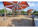 Community playground with modern equipment and shade canopies offers a fun and safe space for children to play at 14513 Winter Stay Dr, Winter Garden, FL 34787