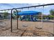 Swings overlook a shaded playground with slides, swings, and climbing structures, creating a safe and fun environment at 14513 Winter Stay Dr, Winter Garden, FL 34787