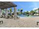 Community pool with a splash zone, lounge chairs, and palm trees at 14513 Winter Stay Dr, Winter Garden, FL 34787