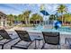 Resort-style pool with a water slide, beach chairs, and lush tropical landscaping, perfect for Gathering fun at 14513 Winter Stay Dr, Winter Garden, FL 34787