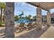 Charming poolside lounge featuring a shady pergola and stone pillars offers a relaxing retreat at 14513 Winter Stay Dr, Winter Garden, FL 34787