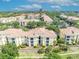 Beautiful aerial view of multi-Gathering complex with yellow buildings, green trees, and ample parking at 1460 Lake Shadow Cir # 7102, Maitland, FL 32751