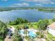 An incredible view from a pool near a lake, with palm trees and lounge chairs at 1460 Lake Shadow Cir # 7102, Maitland, FL 32751
