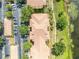 A top-down aerial view of a condo building, parking lot, and next to a lake at 1460 Lake Shadow Cir # 7102, Maitland, FL 32751