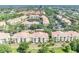 Extensive condo complex featuring a pond, manicured landscaping, and yellow buildings with terra cotta roofs at 1460 Lake Shadow Cir # 7102, Maitland, FL 32751