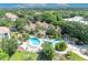 Aerial shot of a pristine community pool with palm trees and lush landscaping at 1460 Lake Shadow Cir # 7102, Maitland, FL 32751