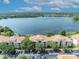 Aerial view of condo buildings overlooking a lake with a backdrop of the city at 1460 Lake Shadow Cir # 7102, Maitland, FL 32751