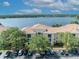 An aerial view of condos in front of a lake with parking and landscaping at 1460 Lake Shadow Cir # 7102, Maitland, FL 32751
