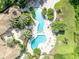 Birds-eye view of a luxurious community pool, sun deck, and mature palm trees at 1460 Lake Shadow Cir # 7102, Maitland, FL 32751