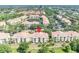 An aerial view of a condo community with a lake, trees, parking, and a red locator on top of the building at 1460 Lake Shadow Cir # 7102, Maitland, FL 32751