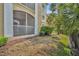 A condo backyard with a screened in porch, some bushes, and some dry grass at 1460 Lake Shadow Cir # 7102, Maitland, FL 32751