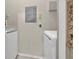 A bright laundry room featuring a white washing machine and dryer, with electrical panel on the wall at 1460 Lake Shadow Cir # 7102, Maitland, FL 32751