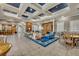 Bright living room with coffered ceilings, fireplace, built-in shelves and access to bar area and dining space at 1460 Lake Shadow Cir # 7102, Maitland, FL 32751