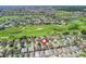 Panoramic view of a residential area in a golf course community with lush greenery and scenic water features at 1642 Pennecamp Dr, The Villages, FL 32162