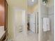 Bright bathroom featuring a tiled shower with glass door, and a neutral color palette at 1642 Pennecamp Dr, The Villages, FL 32162
